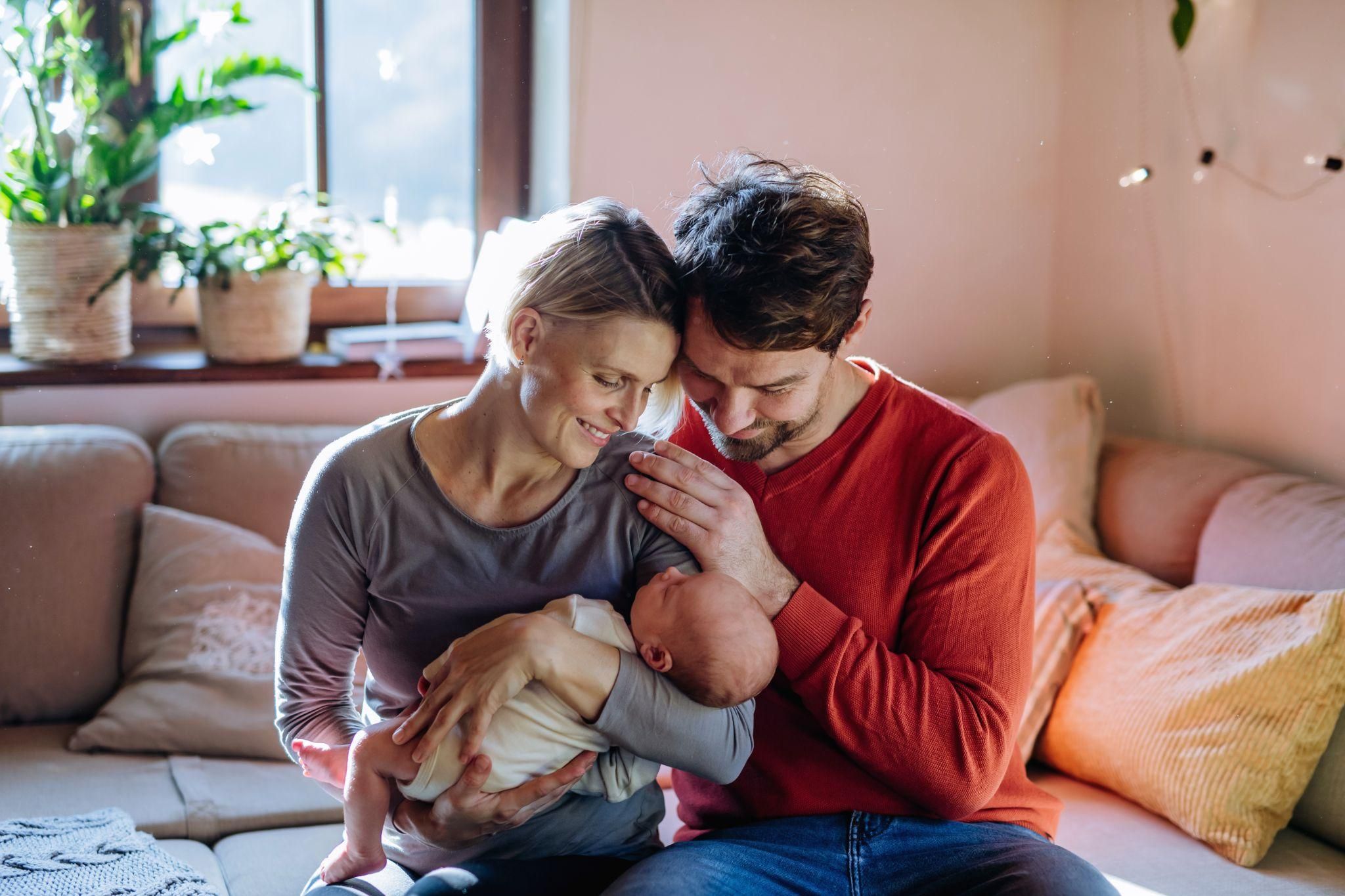 Pregnant couple with newborn.