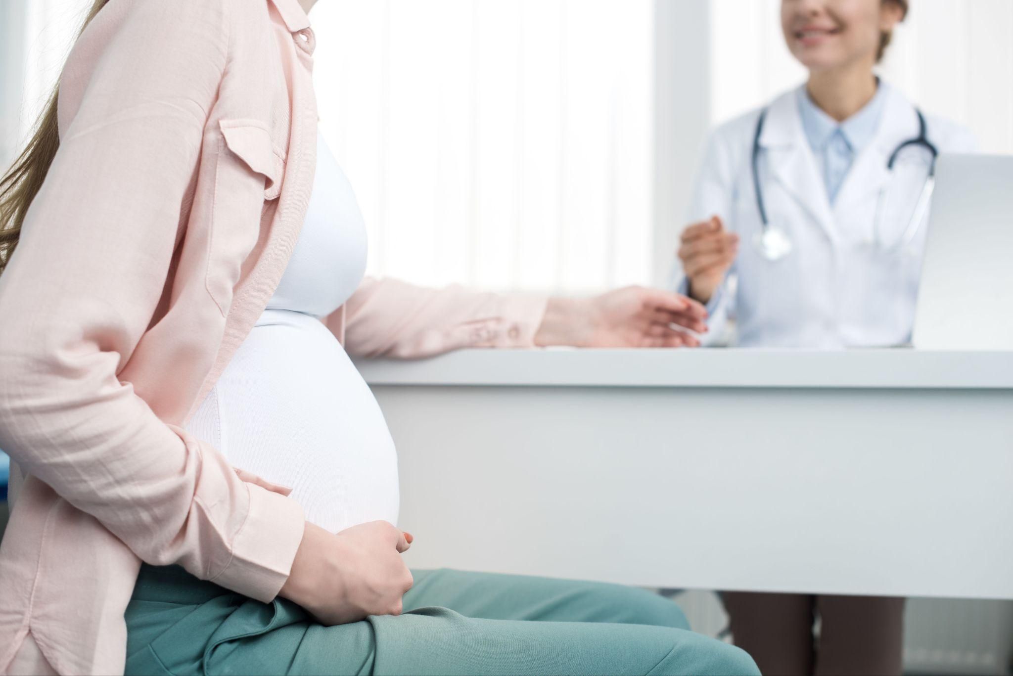 Pregnant woman attending an antenatal class in a rural setting, demonstrating yoga for pregnancy.