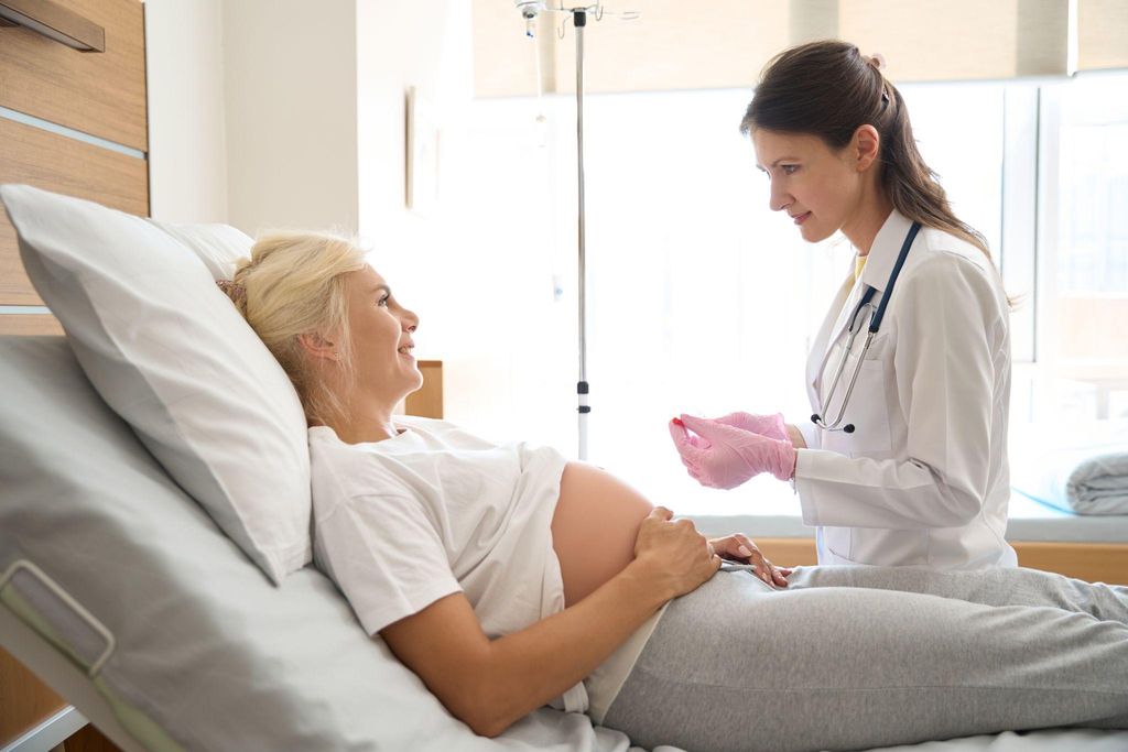 Pregnant woman attending antenatal appointment with midwife.