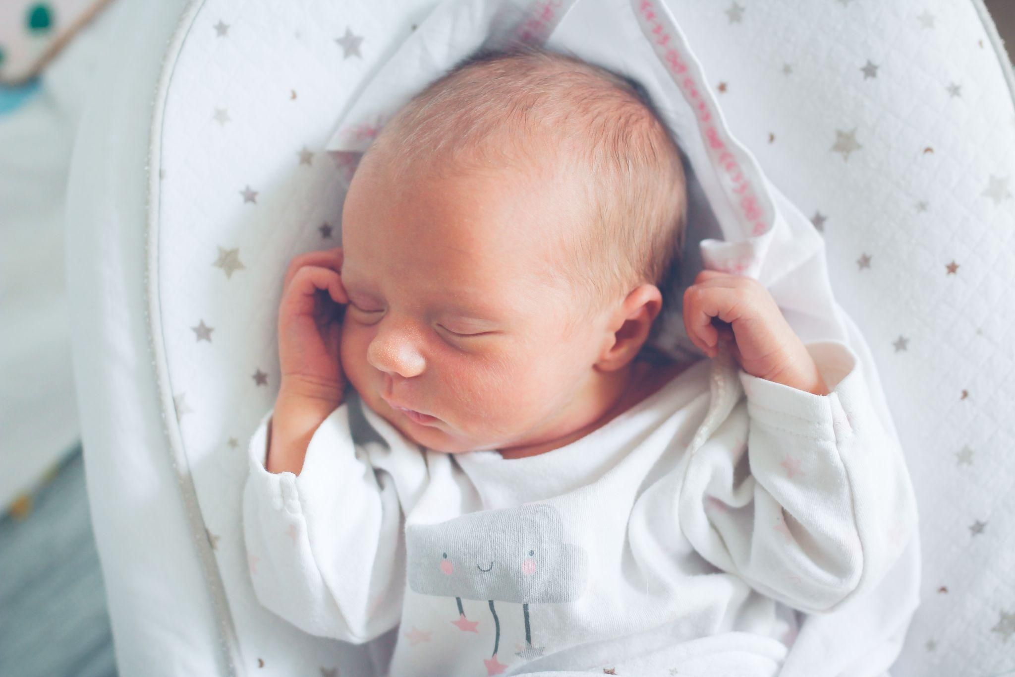 Healthy newborn home from hospital sleeping safely on their back.