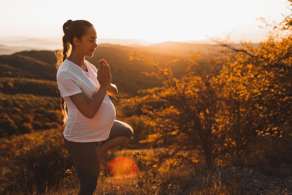 Pregnant woman practising antenatal yoga for relaxation and fitness.