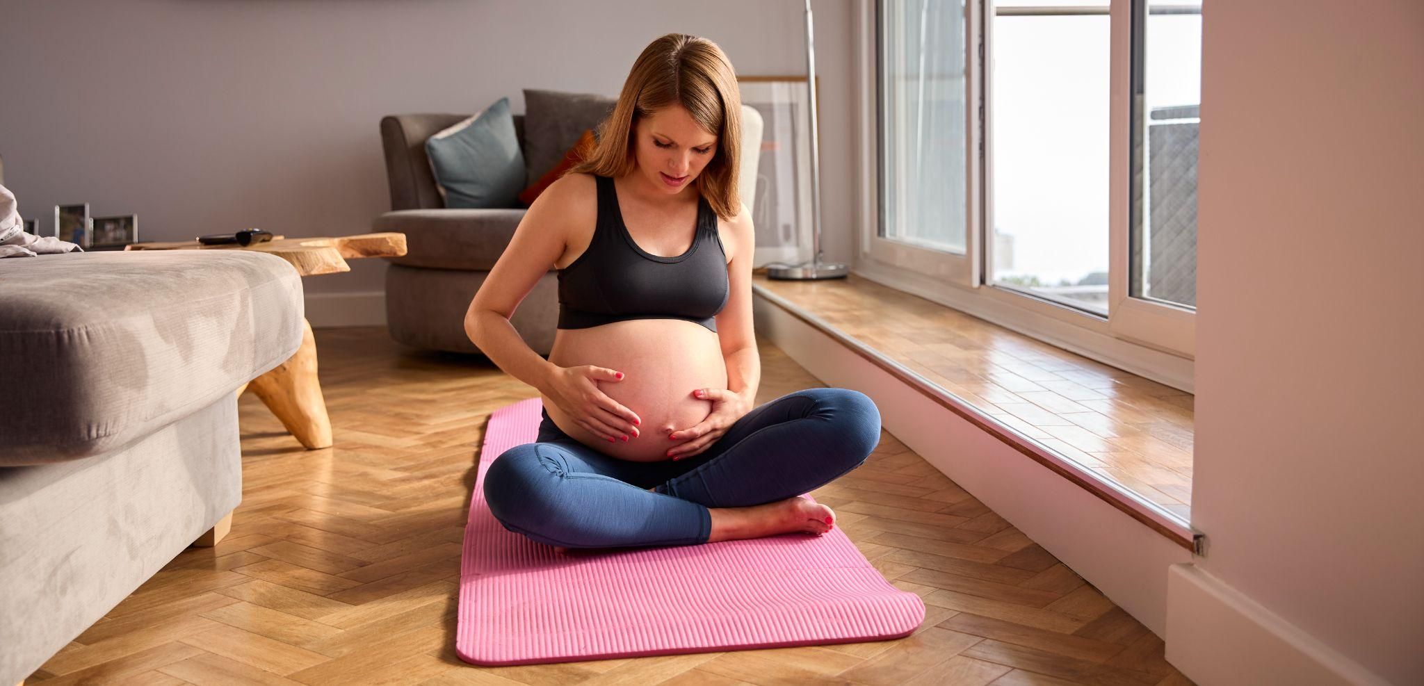 Pregnant woman practising antenatal yoga for birth preparation