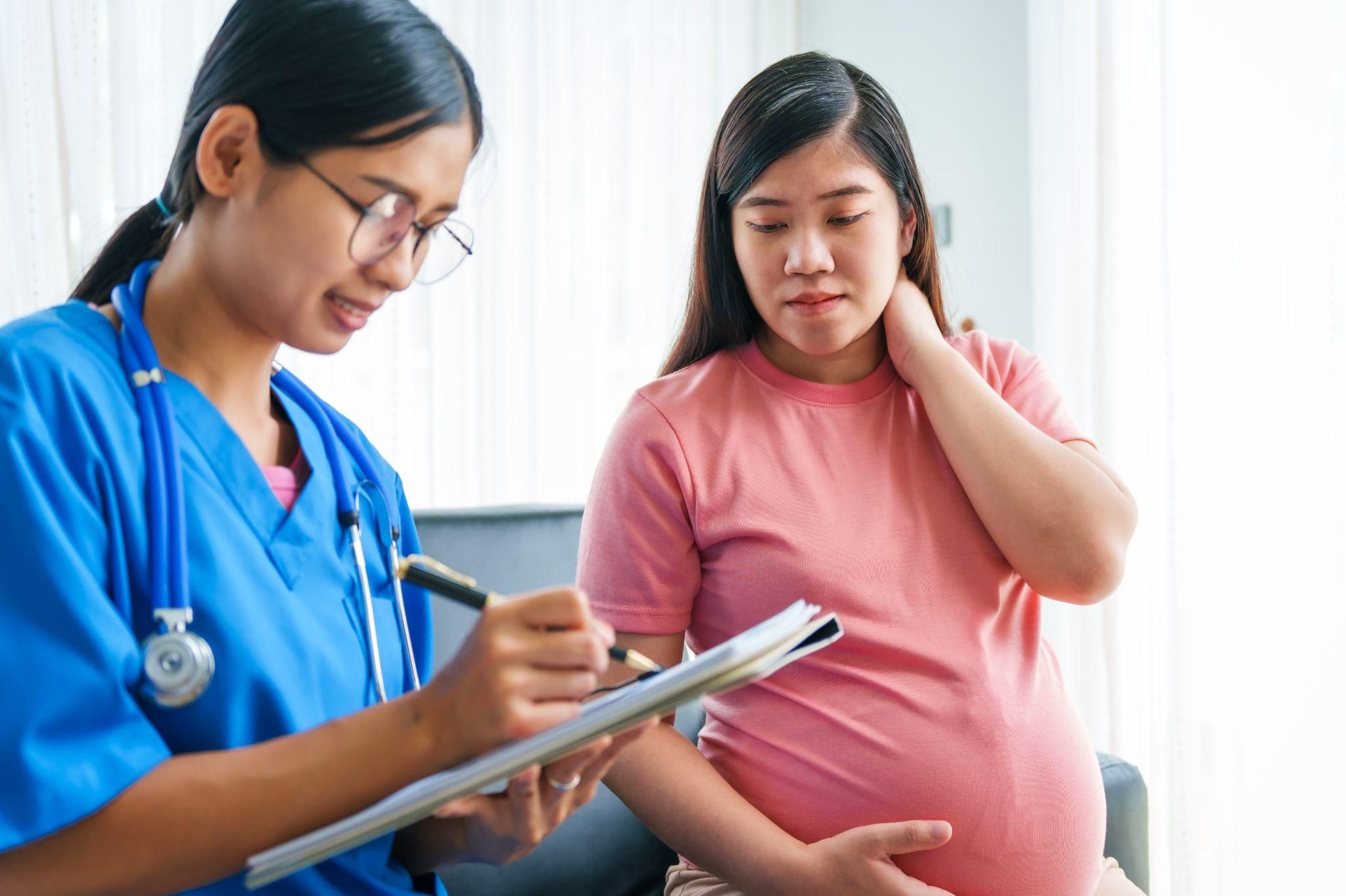 A healthcare professional administering antenatal steroids to a pregnant woman at risk of preterm birth.