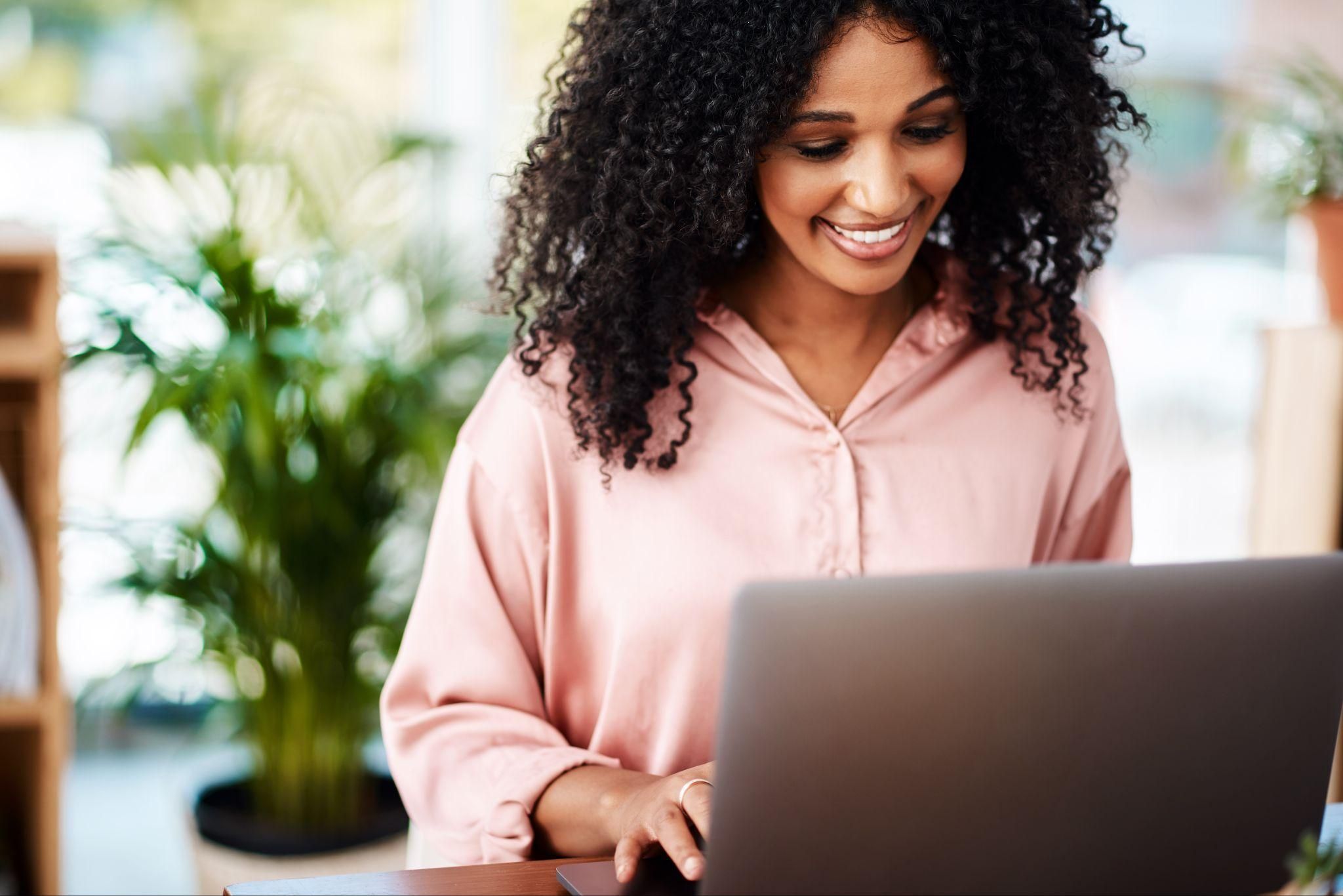 A digital pregnancy test webpage open on a laptop with a home pregnancy test kit next to it.