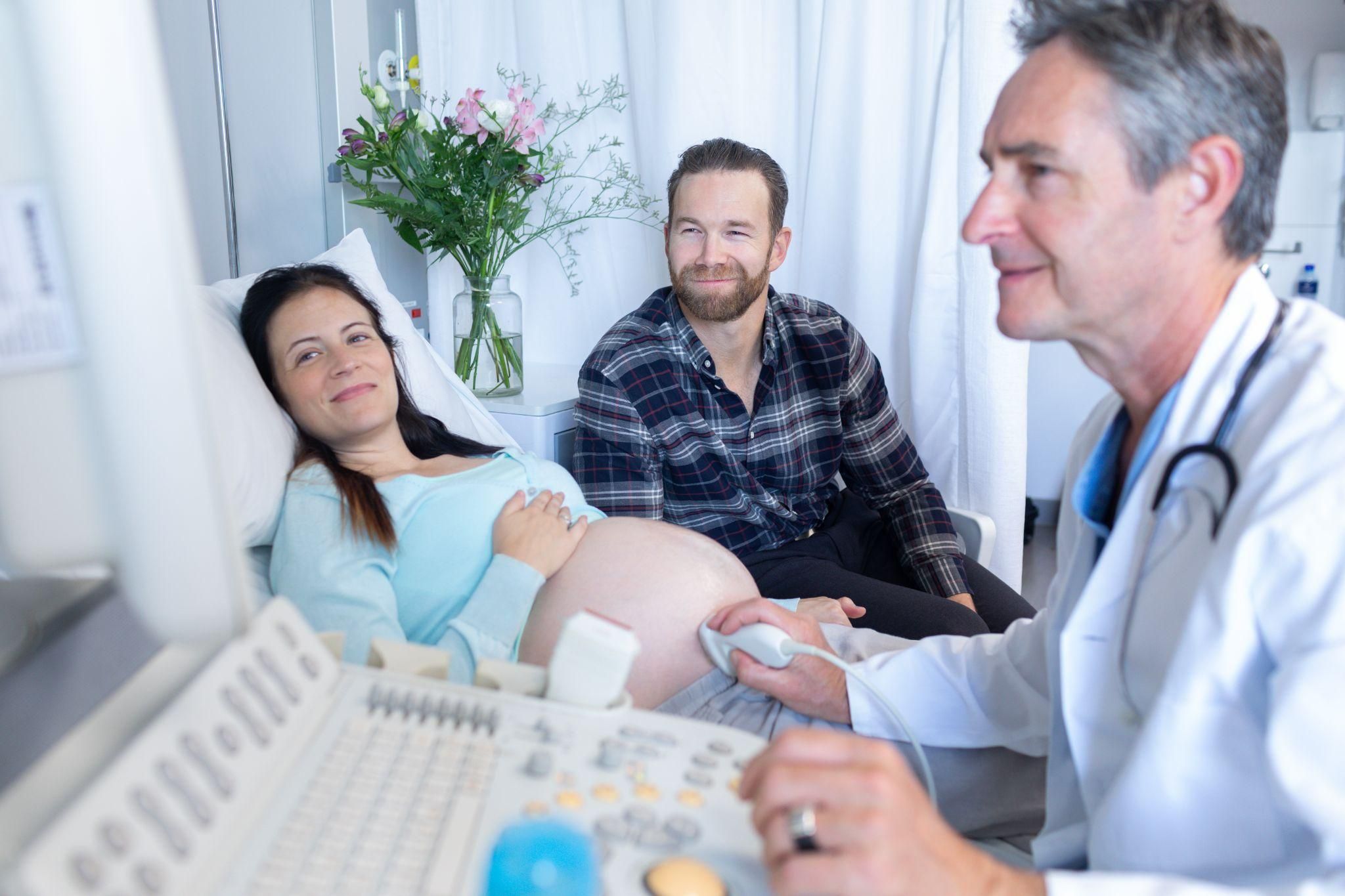 Pregnant woman has antenatal ultrasound scan in late pregnancy during an antenatal appointment.