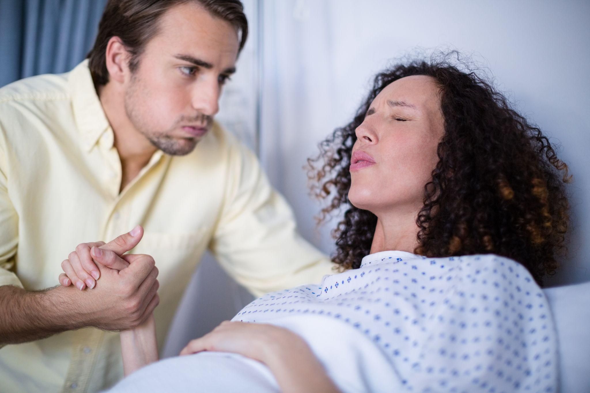 A midwife providing reassurance and support during a woman’s labour.