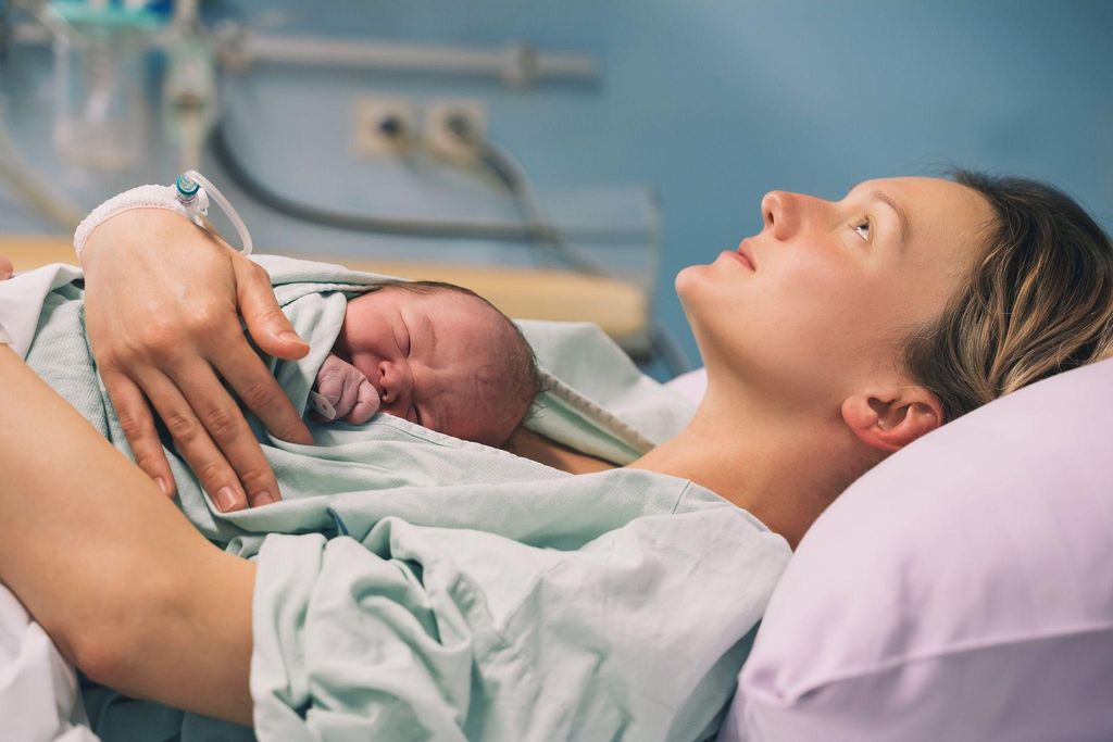 A pregnant woman practising yoga in a warm and sunny room, symbolising the benefits of antenatal care.