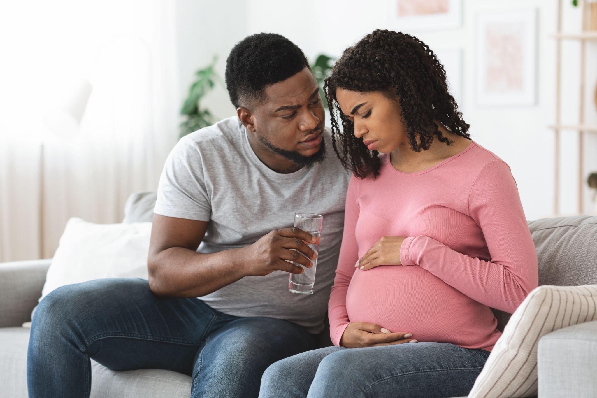 A supportive partner comforting his pregnant wife while discussing antenatal emotions.