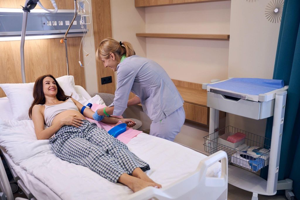 Pregnant woman receiving a blood test as part of diagnostic testing.