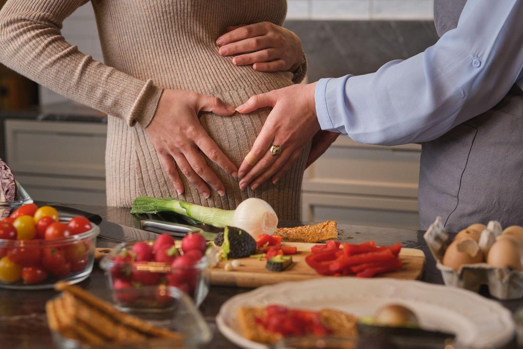 Prenatal vitamins with fruits on a kitchen counter.