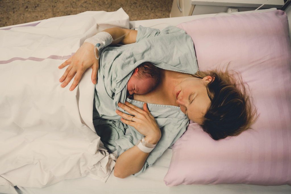 Doctors conducting a Caesarean section procedure in an operating theatre.