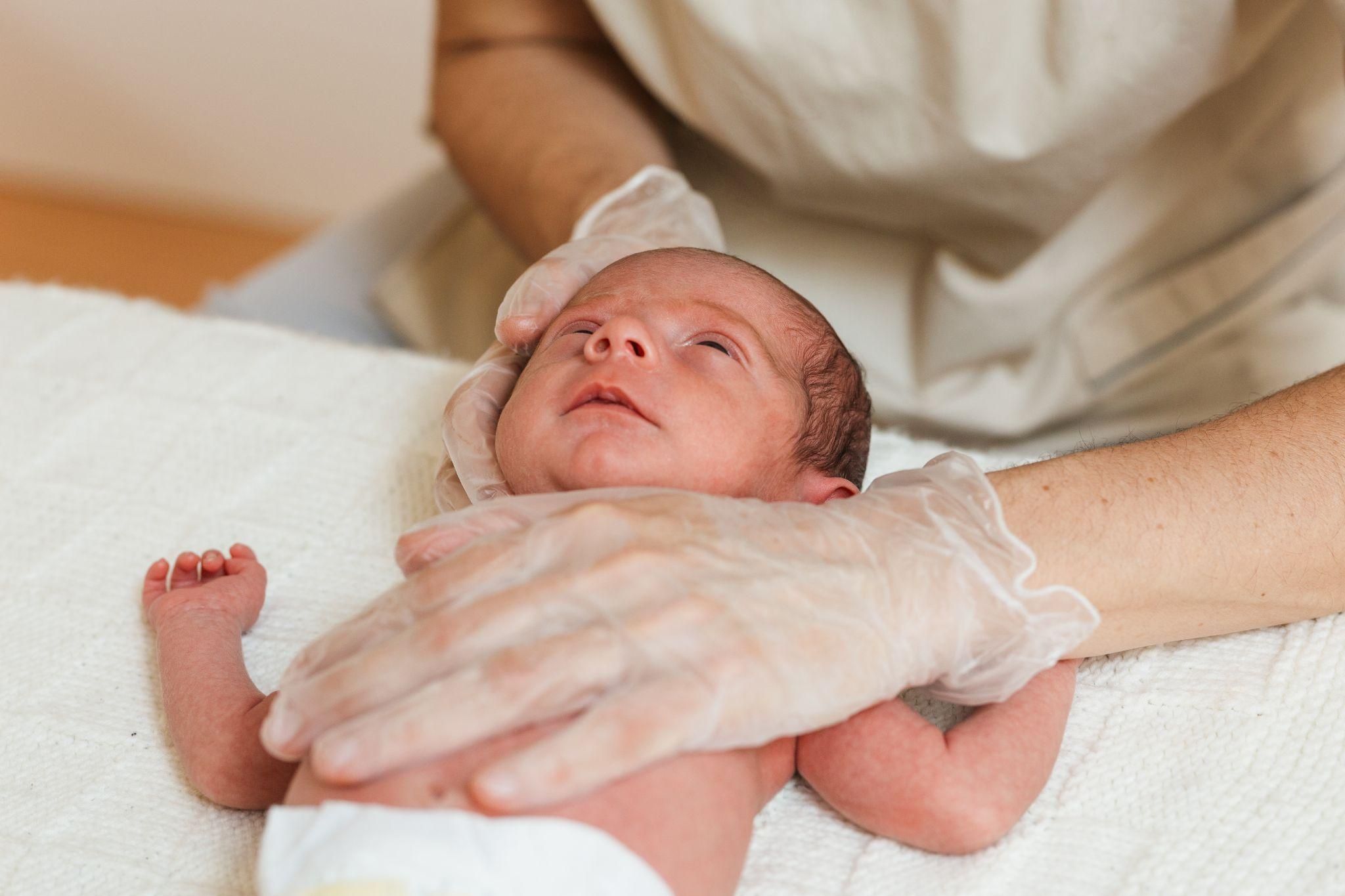 Pregnant couple discussing birth options with their healthcare provider in a clinic setting.