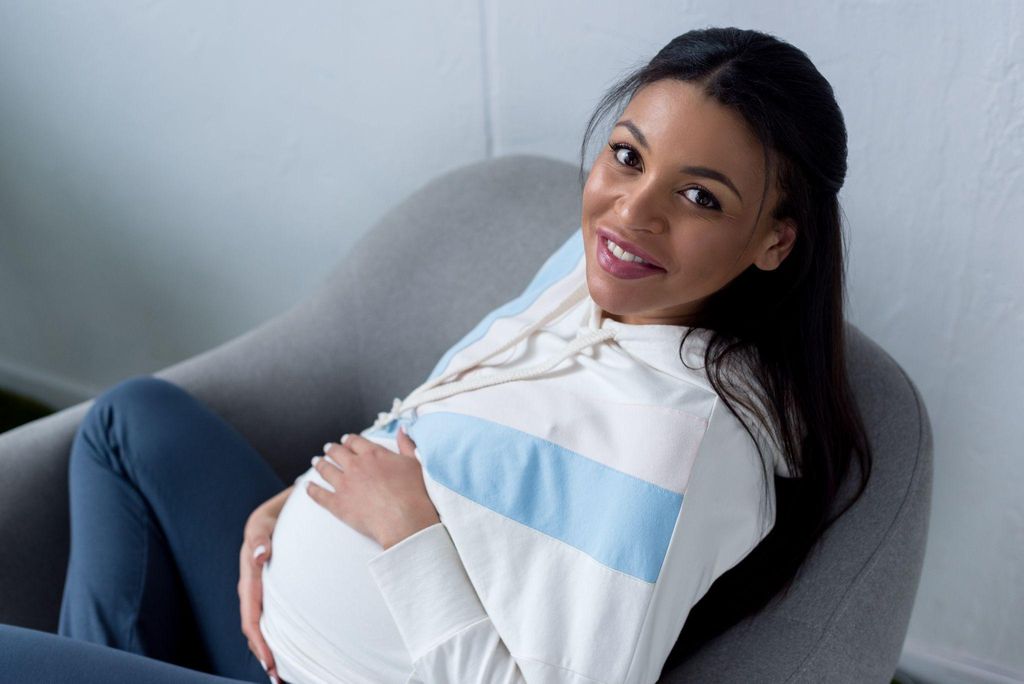 A doula providing antenatal support to a pregnant woman in London.