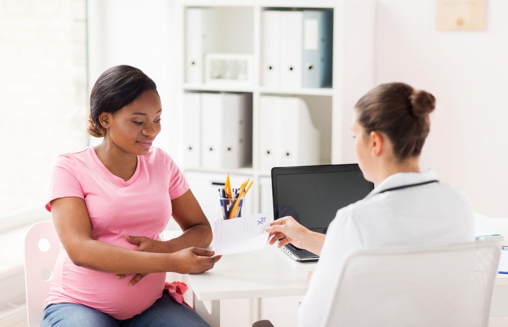 Pregnant woman consulting with her doctor about health concerns during pregnancy. Meta Title: What If I Get Mpox (Monkeypox) in Pregnancy? Key Information for Expecting Mothers