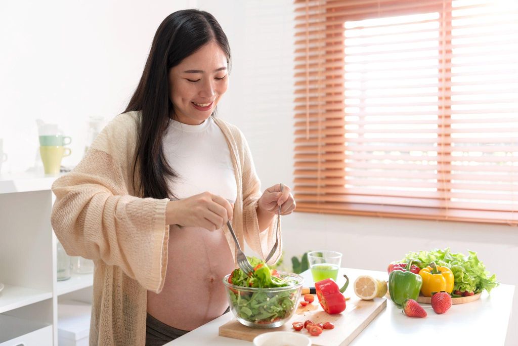 A pregnant woman enjoying a balanced diet during her antenatal journey.