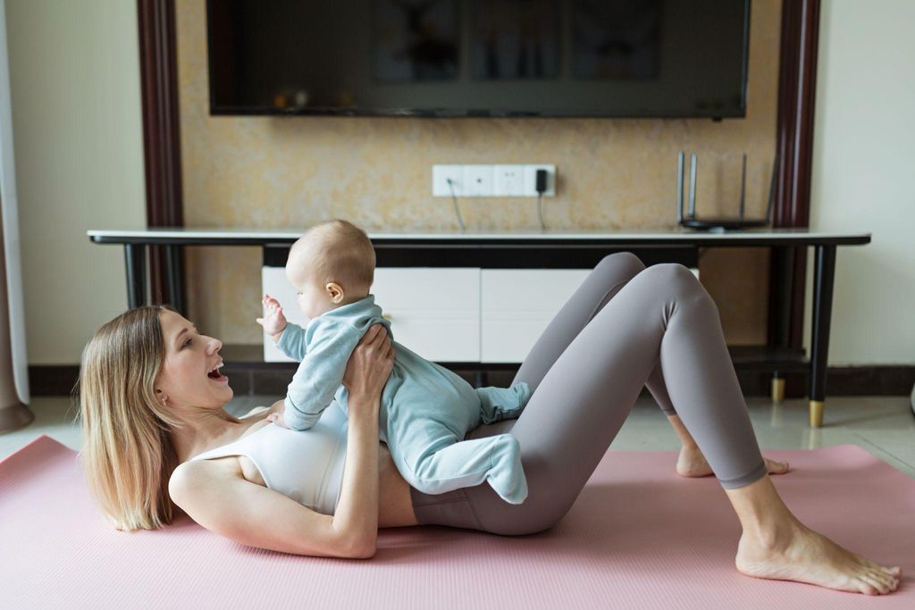 A mother practising postpartum yoga in a peaceful home environment, enhancing physical fitness and emotional wellbeing.