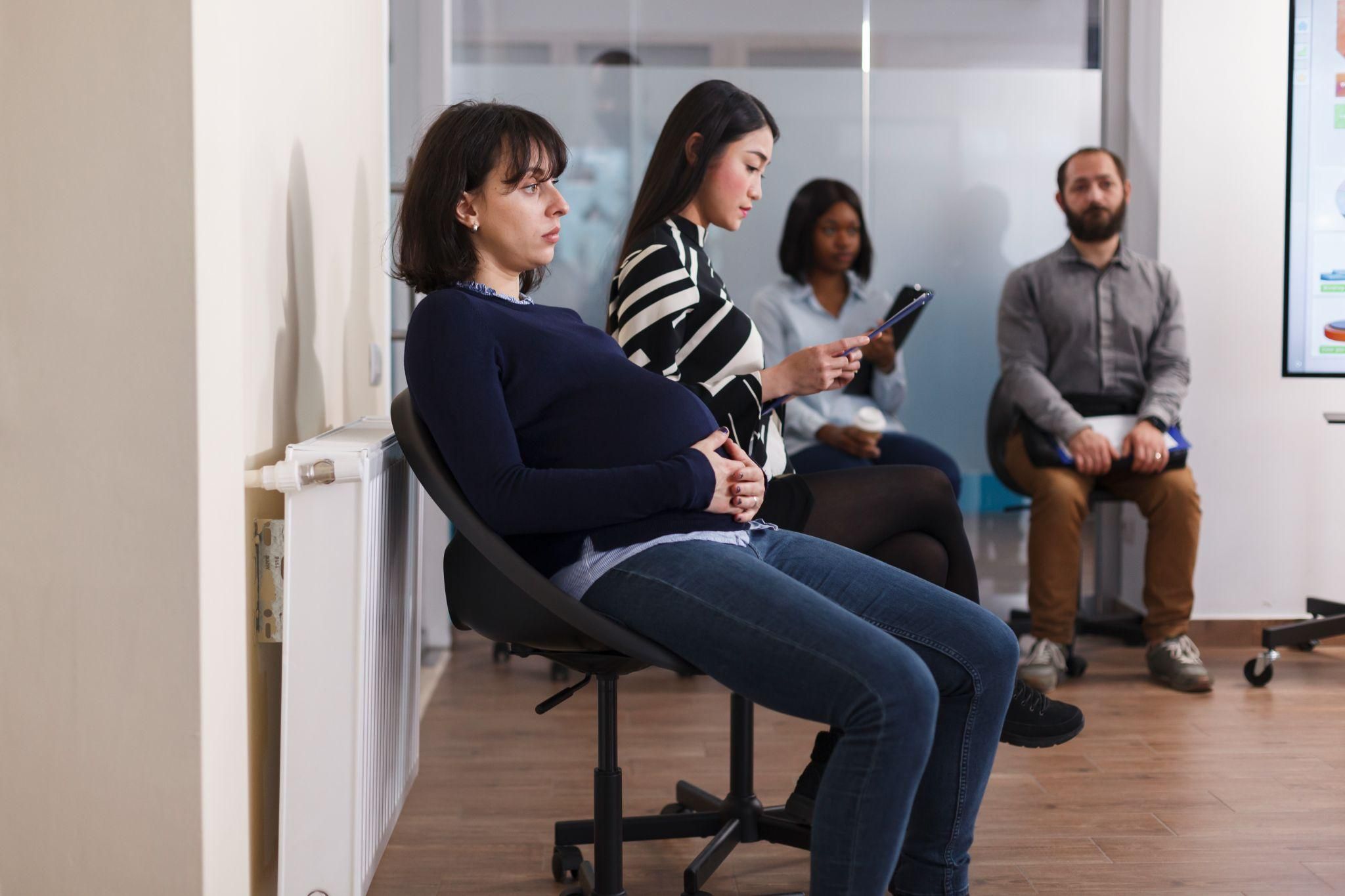 A pregnant woman attending her antenatal appointment in a London hospital, preparing for a planned C-section.