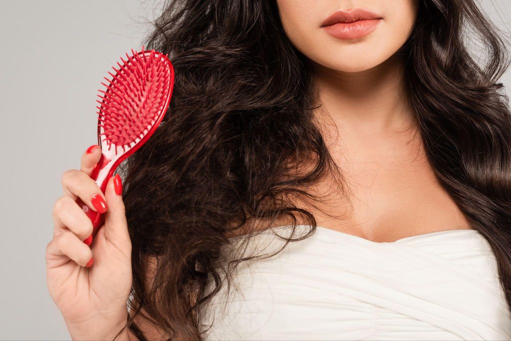 A mother practising self-care with a gentle hair care routine after pregnancy.