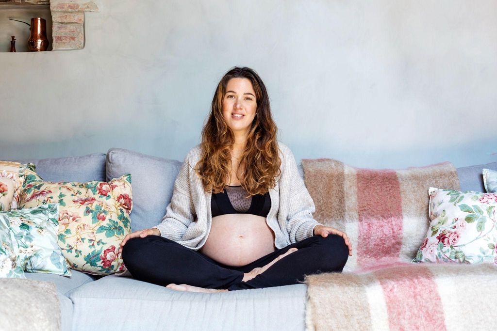 Pregnant woman practising antenatal yoga to relax and prepare for childbirth.