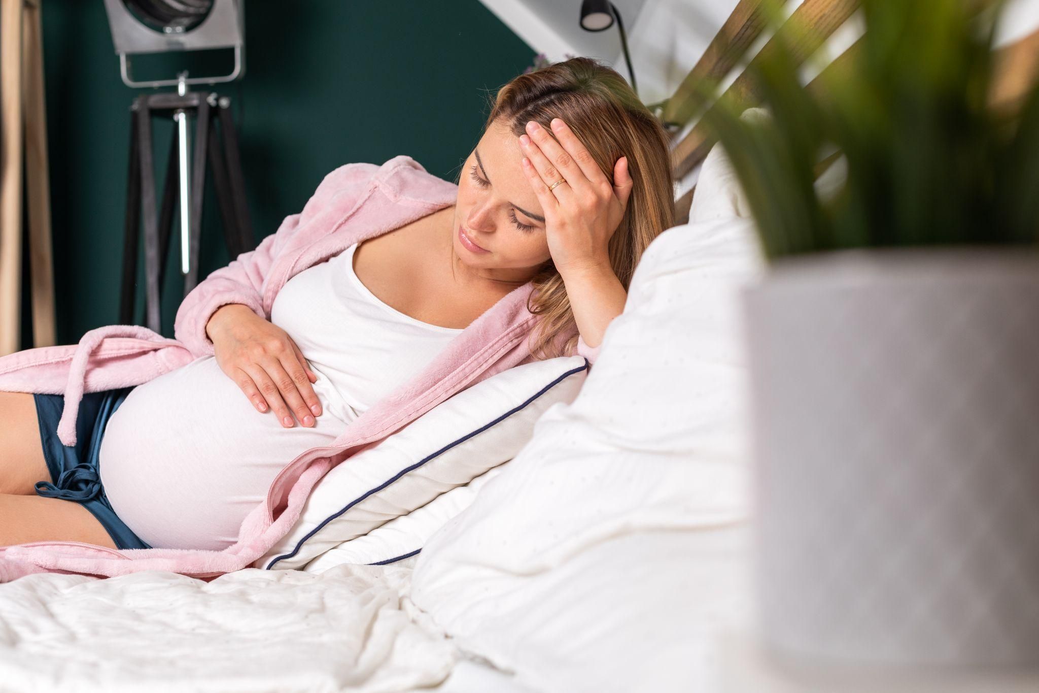 A pregnant woman meditating on managing antenatal stress and protecting her baby.